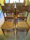 Four oak pressback chairs with cane seat