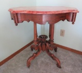 Unusual marble top table with salmon colored marble, walnut