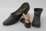 Two metal shoes and plastic dog in shoe