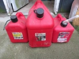 Three plastic gas cans, 5 and 2 gallon