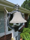 Cast metal bell with eagle finial and yoke