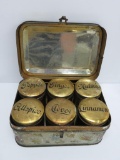 Unusual tin spice set with six tins and ornate storage tin