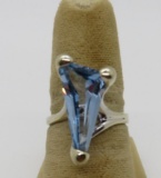 10kt white gold solitaire ring set with a blue triangular step cut created glass stone