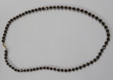Spherical garnet beads alternating with 14 kt yellow gold beads, 23