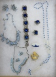 Nine pieces of blue glass and rhinestone costume jewelry