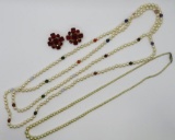 Two imitation pearl necklaces and red rhinestone earrings