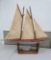Large wooden sailboat with metal trim and rudders, 36