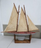 Large wooden sailboat with metal trim and rudders, 36