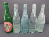Five vintage bottles, Milwaukee Waukesha Brewing Co and Clysmic table water bottles