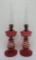 Pair of handpainted cranberry glass oil lamps, 22
