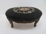 Ornate carved footstool with needlepoint top, 19