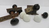 Three porcelain door knob sets and four loose