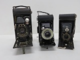 Three vintage Kodak folding cameras