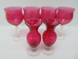 Four cranberry bowl stems and pair of cranberry vases