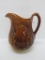 Rockingham Bennington Style milk pitcher with wreath design, 9 1/2