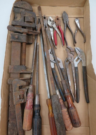 Large lot of tools, pipe wrench, long shafted screwdrivers, pliers and snips
