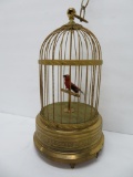 Mechanical singing bird in ornate metal cage, 11