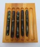 Five vintage Parker and Sheaffer fountain pens and wooden display stand