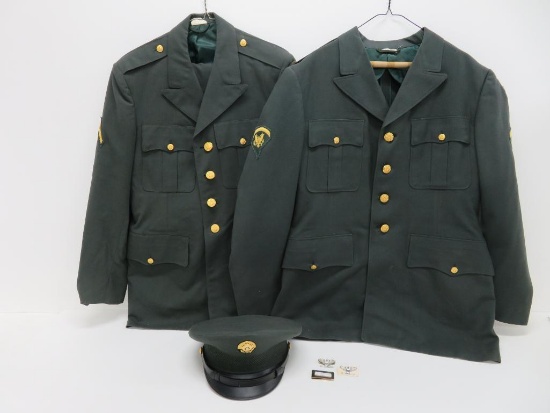 Two US Army dress uniforms with hat, patches and emblems
