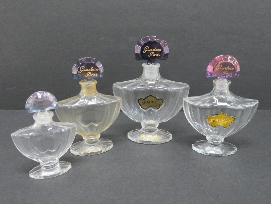 Four Guerlain Paris Shalimar perfume bottles, 3" to 4 1/2"