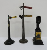 Three Lionel accessories, signal lights and signs