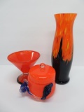 Three orange Deco style pieces of glass, covered dish and vases