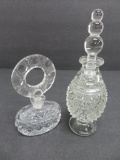 Two ornate perfume bottles with stoppers