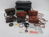 Five vintage 35 mm cameras with cases