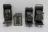 Three Kodak folding cameras and one Kodak Brownie box camera