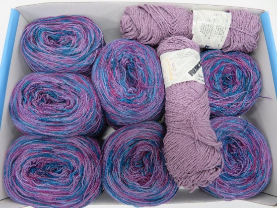 11 rolls and skeins of purple and multi color yarn