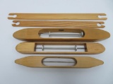 Three wooden boat shuttles and two flat stick shuttles