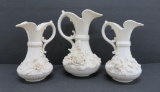 Three ornate Belleek pitchers, applied floral and leaf decoration, 6