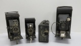 Three Kodak and Deltax folding cameras and Kodak Cine Model B movie camera with case