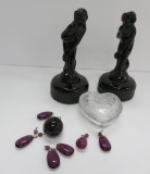 Two amethyst colored glass Venus Rising figures, amethyst colored prisms and clear covered bird box