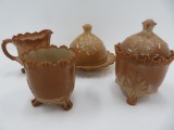 Four pieces of Green Town chocolate slag glass, covered butter, cream, sugar and spooner, 4