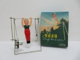 Celluloid tin wind up acrobat toy with box and paperwork, Single Bar Exercise, 7 1/2