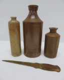 Three stoneware ink bottles and brass letter opener