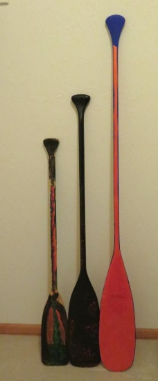 Three wooden paddles, 46" to 66", painted for decor