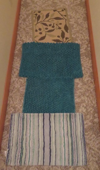 Four bathroom kitchen rugs, blues and greens