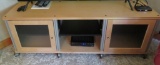 Entertainment cabinet, natural finish, on rollers, 66