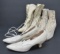 Three pair of white leather shoes and boots