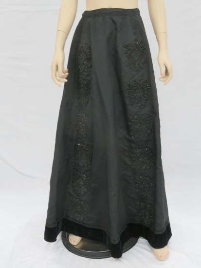 Black satin type skirt with beaded embellishments and velvet trim