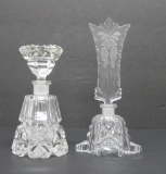 Two cut crystal perfume bottles, one with floral swag stopper, 5 1/2