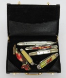 Seven vintage mini pen knives with a storage case