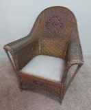 Nice wicker side chair with red and black design on back and skirt