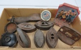 Cast iron lot with five sad irons, shoe lathe, bookends,skillet and covered dish