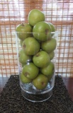 Large glass vase with decorative apples