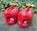 Two 5 gallon plastic gas cans, 3/4 and 1/2 full respectively