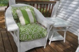 Wicker patio chair and side table with lovely outdoor cushion and pillow