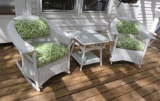 Two outdoor patio wicker rockers and table with lovely outdoor cushions